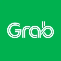Logo Grab hadir dengan huruf putih di atas latar belakang hijau, melambangkan layanan transportasi dan pengantaran yang modern dalam konteks urban.